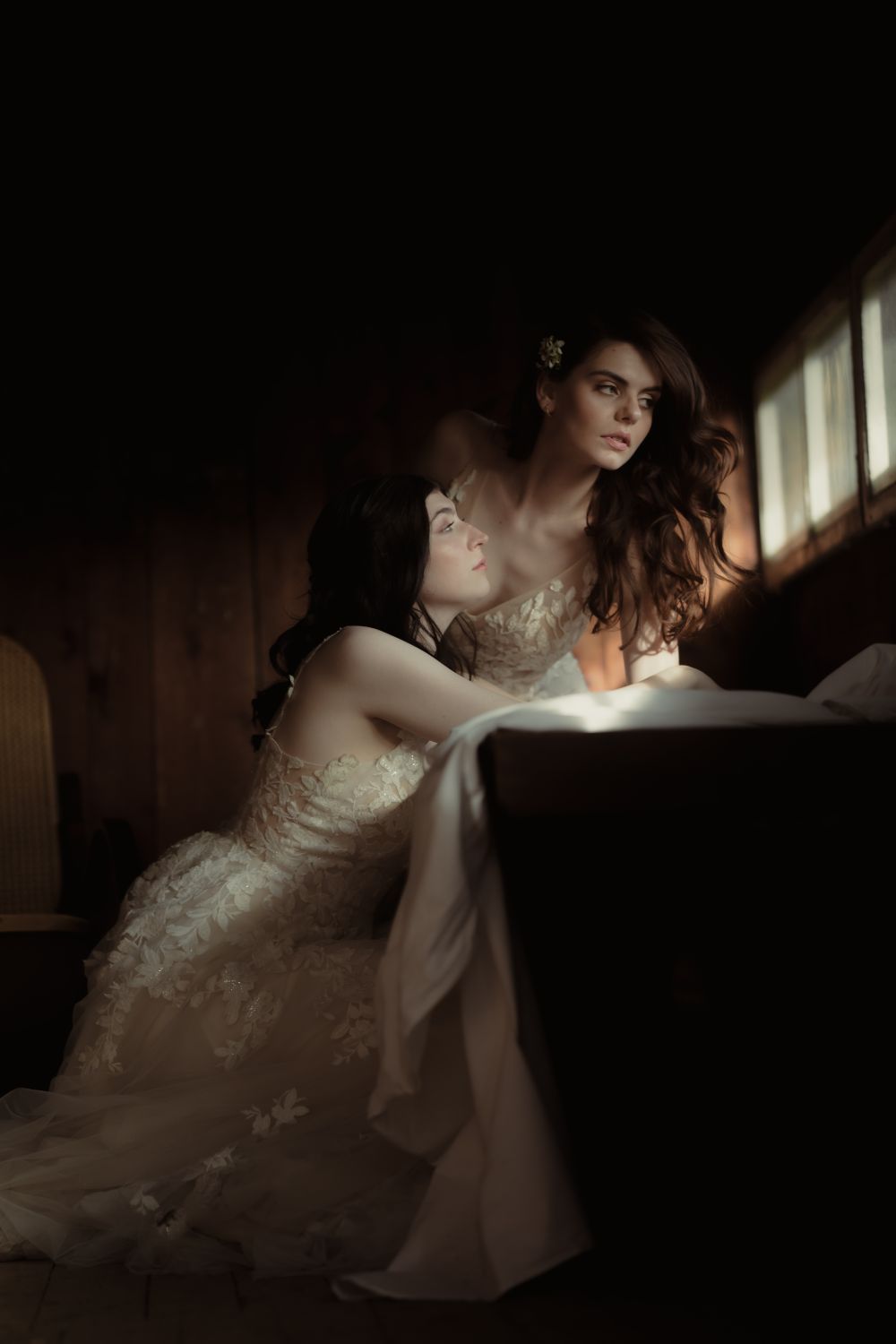 Brautpaarfotos in einer Hütte am Fenster, mit bezaubernden Hochzeitskleidern